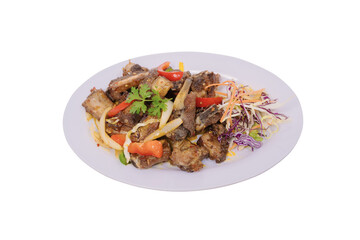a plate of ribs with a colorful assortment of vegetables and garnishes, beautifully arranged on an oval white plate against a white background.