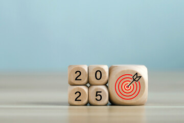 2025 year with the target which prints screens on wooden cube blocks with ideas for Business plans and goals and strategies that will lead to business success and a better life in the new year.