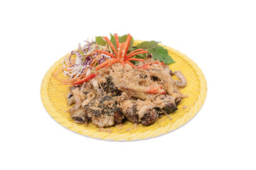 dish of stir-fried frog with lemongrass, garnished with fresh herbs, shredded vegetables, and chili, served on a yellow plate, showcasing a colorful and exotic culinary presentation.