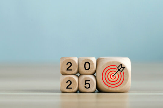 2025 year with the target which prints screens on wooden cube blocks with ideas for Business plans and goals and strategies that will lead to business success and a better life in the new year.