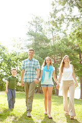 Family, love and holding hands in park for portrait, trust or excited for adventure in Australia. Parents, children or gesture in nature for guidance, support and safety on holiday or summer vacation