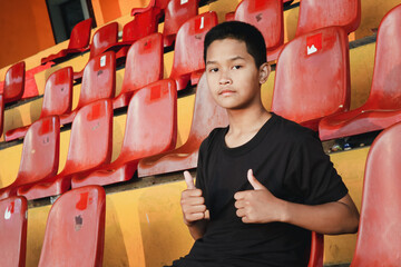 A teenager giving a thumbs up, a sign of approval