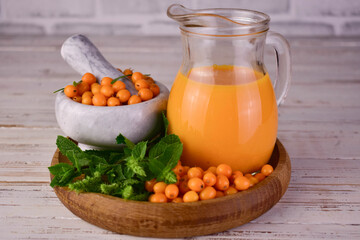 Juice from sea buckthorn berries. Vitamin drink.