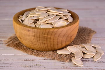 Pumpkin seeds in a wooden bowl.Close-up.
