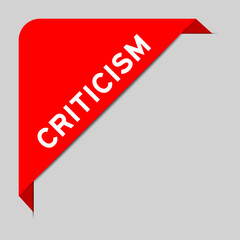 Red color of corner label banner with word criticism on gray background