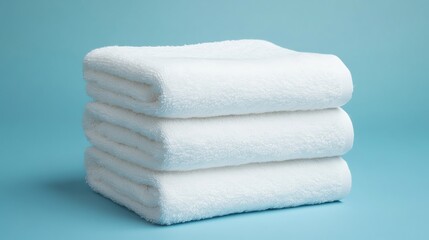 A stack of white towels on a blue background.