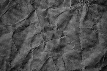 Crumpled black paper texture background.