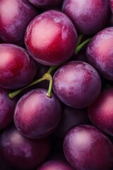 Obraz premium A close-up of juicy plums with water droplets on their surfaces, some forming at the bottom