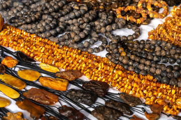 Amber stones market, polished orange gemstones closeup, natural Baltic amber gems jewelry store