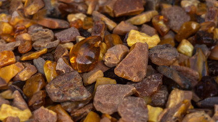 Amber stones market, polished orange gemstones closeup, natural Baltic amber gems jewelry store