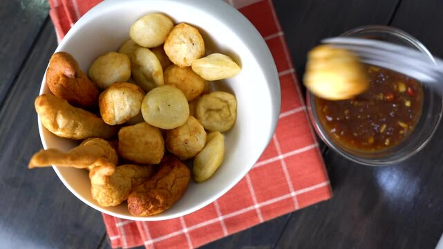 a bowl of kikiam, fish ball and squid ball with sweet chili soy sauce