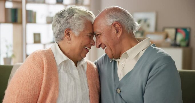 Forehead, love and smile with senior couple on sofa in living room of retirement home together for bonding. Safety, security or trust with elderly man and woman in apartment for support or wellness