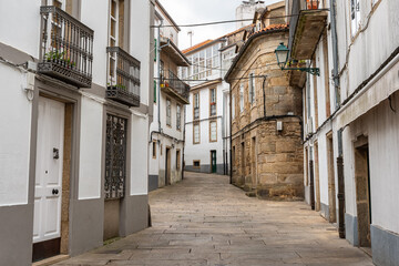 Narrow alleys with old houses and cobbled pavement in the city of Santiago de Compostela, Galicia.