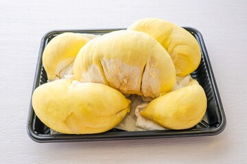 Fresh Durian in black plastic pack on white background, fruit	