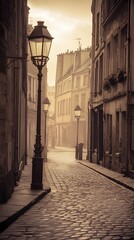 Obraz premium Cobblestone street with vintage lamp posts in a misty European city.
