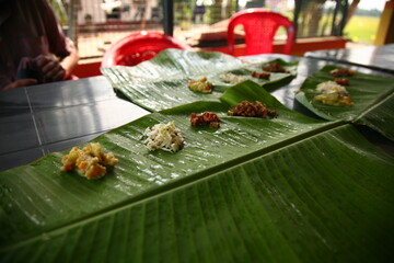 Indian food lying on a palm leaf plate