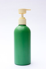 A green plastic bottle packaging. This bottle is a bottle design commonly used in soap, shampoo and beauty cream packaging such as body lotion etc. Use this image as your design mockup.