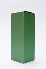 A green cardboard packaging box. This box can be used as a mockup for your packaging design needs.