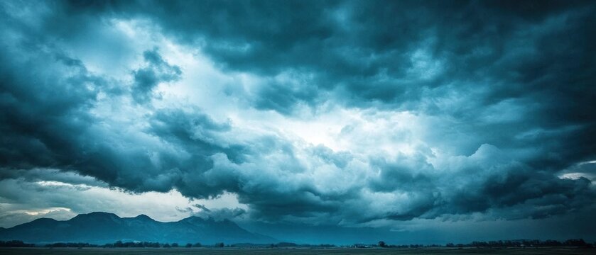 Dramatic stormy sky over a serene landscape highlighting the stark contrast between light clouds and dark, foreboding weather