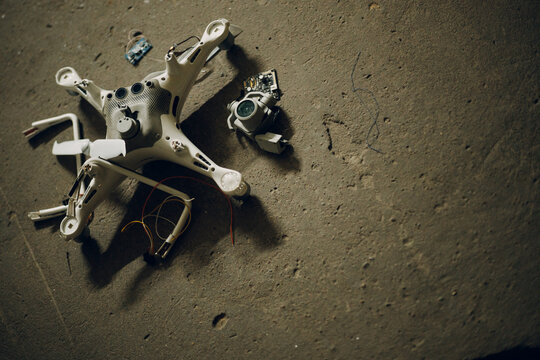 Fallen damaged quadcopter drone crash on floor.