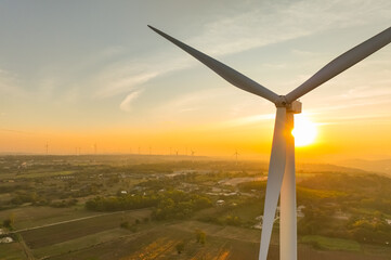 Wind farm field and sunset sky. Wind power. Sustainable, renewable energy. Wind turbines generate...