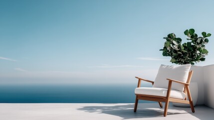 A comfortable white armchair is positioned on a contemporary patio with a spectacular ocean view, capturing the essence of relaxation and scenic beauty in a minimalist outdoor setting.