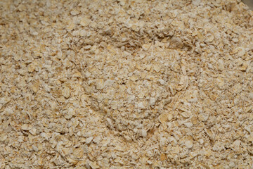 Oat flakes texture background forming love, oatmeal. wheat, carbohydrates