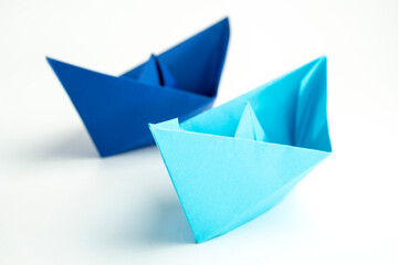 Paper colored boat isolated on white background with reflection. origami crafts. transport concept....