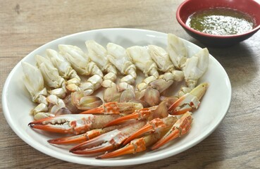 steamed flower crab meat paddle and claw on plate dipping Thai spicy seafood sauce 