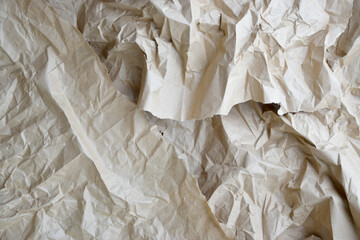 Craft crumpled paper, cardboard background. Brown kraft sheet texture, torn antique page, wallpaper or parchment abstract design, Horizontal rough carton