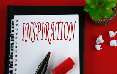 INSPIRATION - word in white notebook on red background