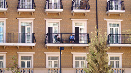 Two ladies talking and relaxing on the balcony . High quality photo