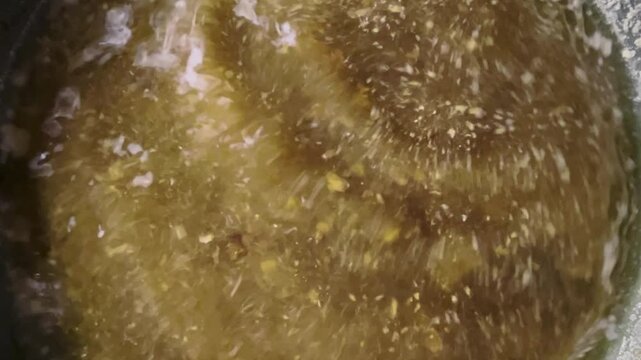 The water in the pot is a yellowish-brown color, with white stains on the surface and small bubbles. Moving dirty water.