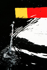 A splash of water is falling from a faucet