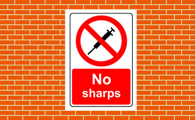 No sharps to be put into this container sign on a wall
