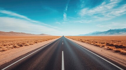 Fototapeta premium A long stretch of an empty highway, cutting through the desert landscape with a single car in the distance, symbolizing freedom and the adventure of a solo road trip.