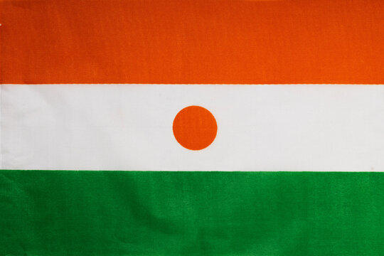 National flag of the state of Niger close-up. State background.