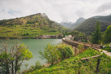 Naklejka premium Dike at Pontechianale in Val Varaita, Italy, 2023. Wall of the dike at Pontechianale. 