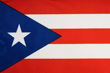 National flag of the state of Puerto Rico close up. State background.