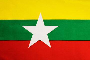 National flag of the state of Myanmar close up. State background.