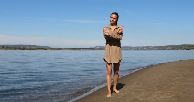 Photo posing - young beautiful girl shows correct poses for a photo on the beach
