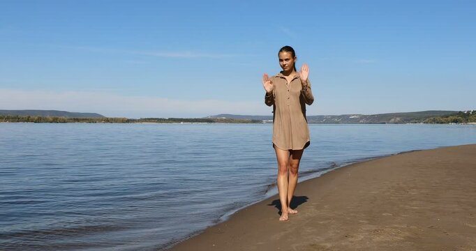 Photo posing - young beautiful girl shows correct poses for a photo on the beach