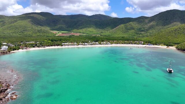 Aerial view of Carlisle Bay with lush rain forest and turquoise and emerald sea, Antigua and Barbuda, Caribbean