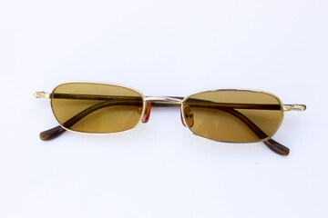 Minimalist Gold-Framed Sunglasses: With its simplicity and neutral backdrop, this high-resolution photograph is ideal for various marketing materials or as an e-commerce product listing photo for eyew