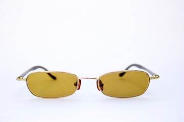 Minimalist Gold-Framed Sunglasses: The front-facing angle provides a clear view of the symmetrical...