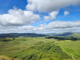 Fototapeta premium Green hills under blue summer sky landscape in Ireland