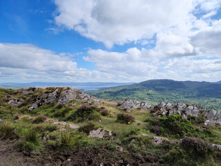 Green hills under blue summer sky landscape in Ireland