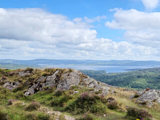 Green hills under blue summer sky landscape in Ireland