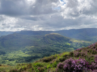 Green hills under blue summer sky landscape in Ireland