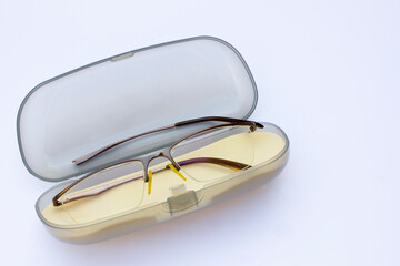 Damaged Eyeglasses: A close-up of a pair of eyeglasses with a broken right arm, detached from the hinge. The metallic frame features thin rims and nose pads, suggesting corrective vision design.